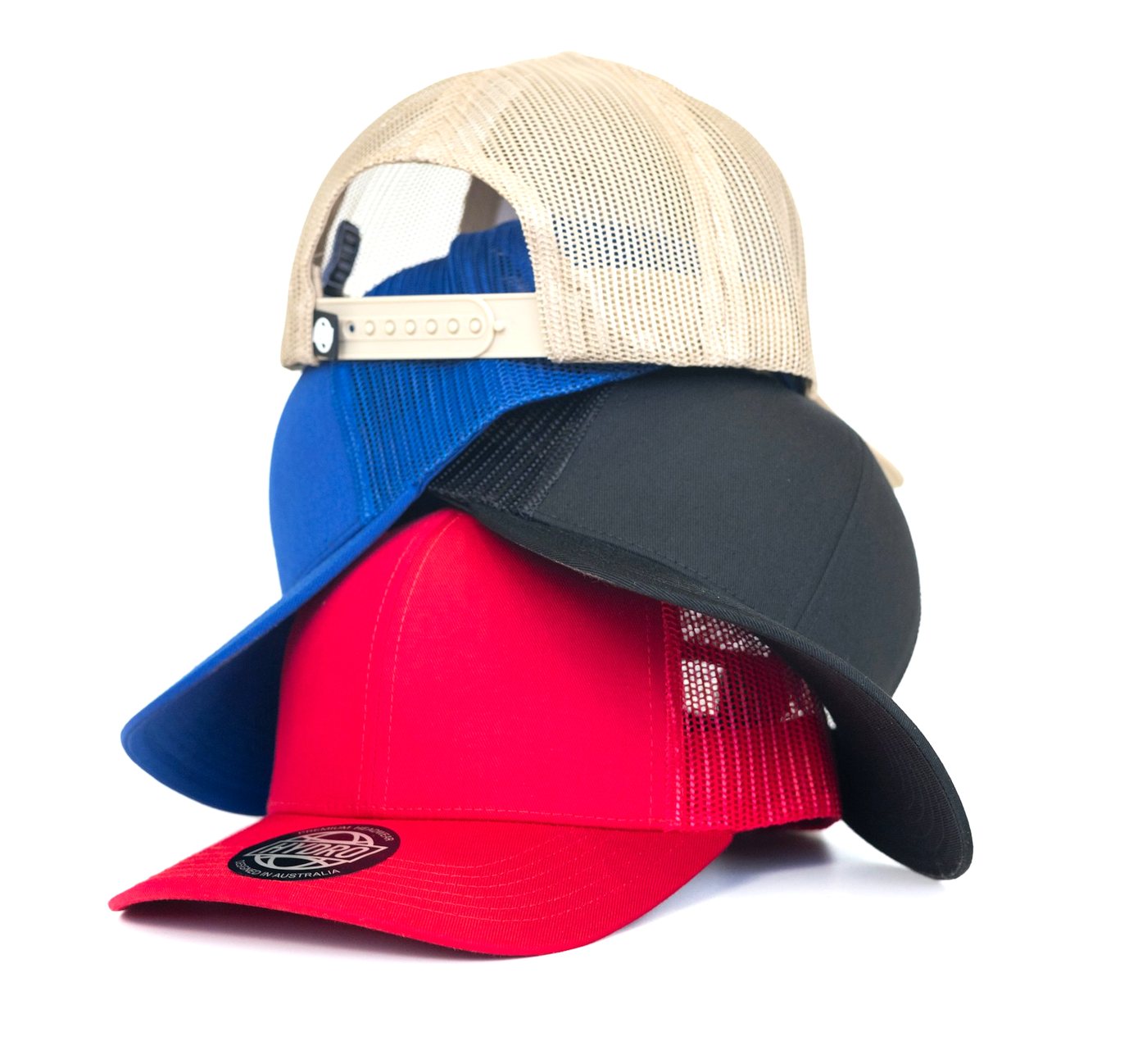 Stacked baseball caps in tan, blue, charcoal, and red